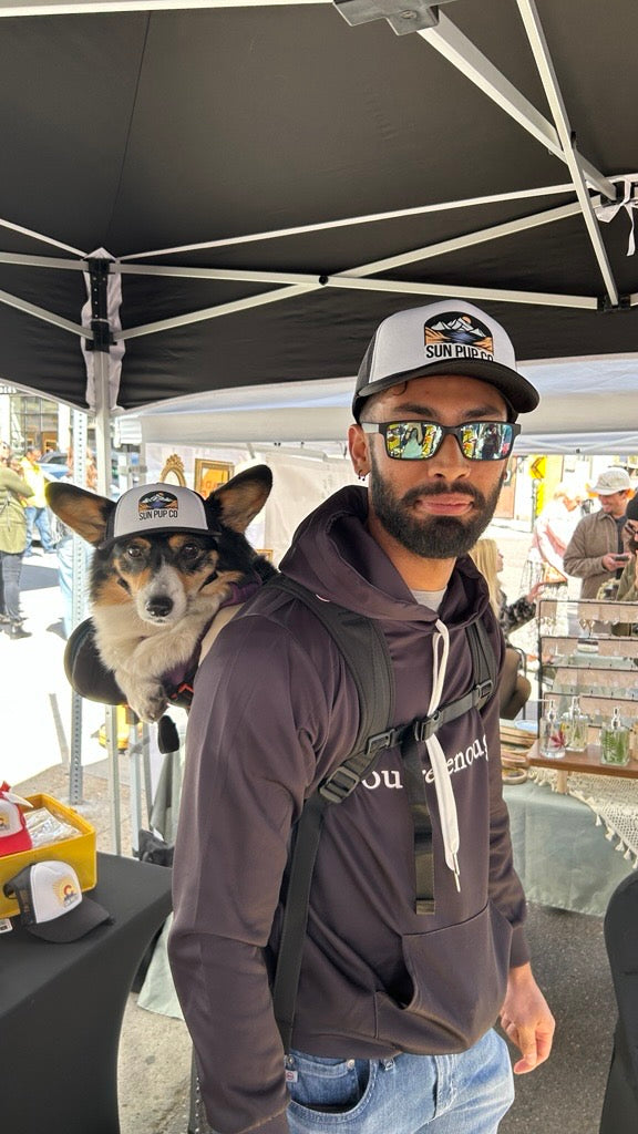 Man and dog wearing matching hats